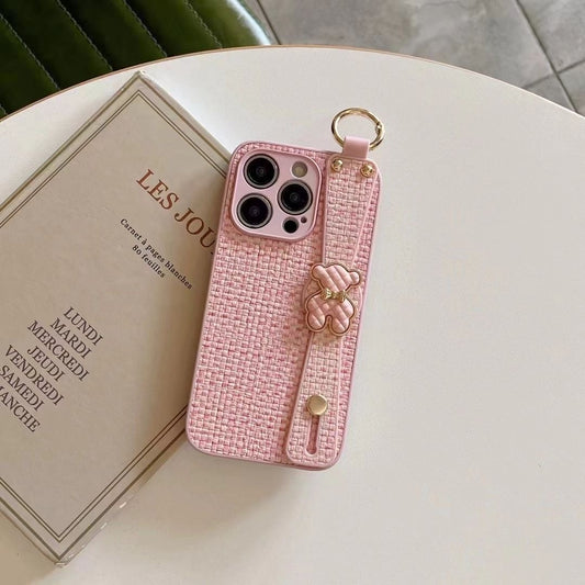 Funda para teléfono con correa para la muñeca y diseño de cuadros tejidos